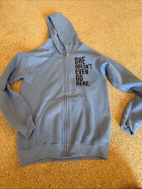 Light Blue Zip-Up Hoodie with 'She Doesn't Even Go Here' Graphic